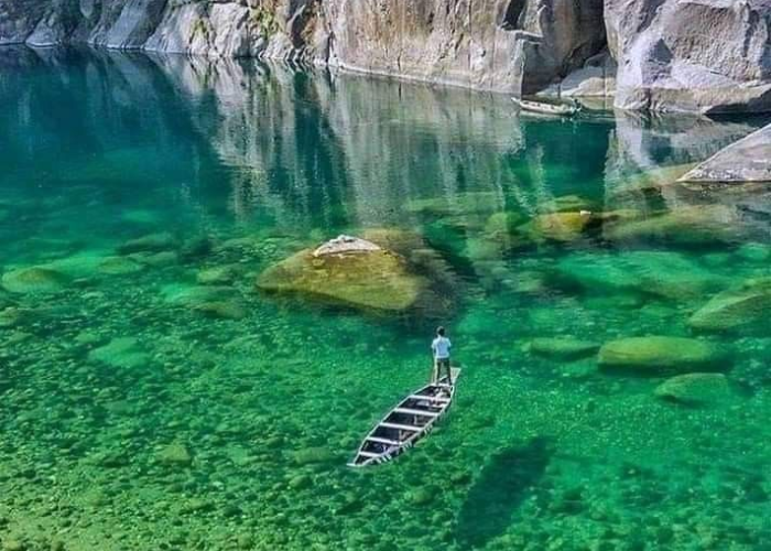 Crystal-clear waters of Dawki River flowing through lush green hills in Meghalaya