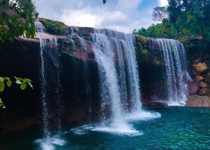 Stunning turquoise waters of Krang Suri Waterfall cascading through rocky cliffs in Meghalaya