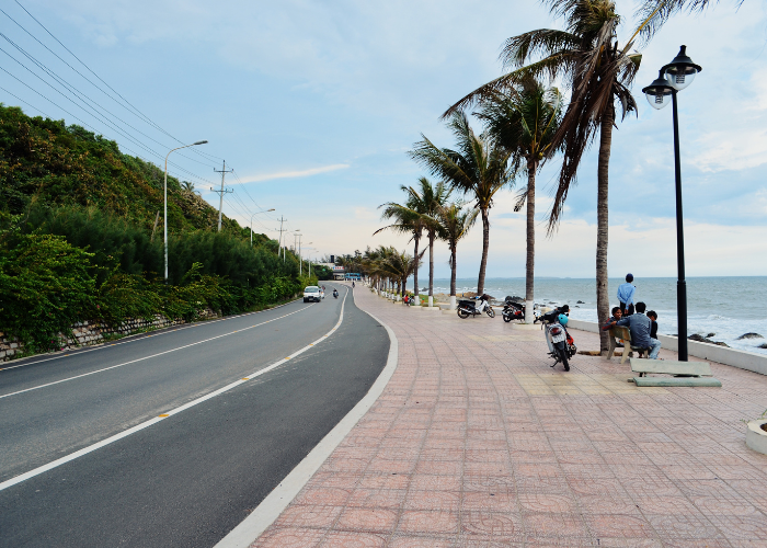 Solo woman walking along Promenade Beach (Rock Beach) in Pondicherry, safe beach destination for solo female travelers in India"