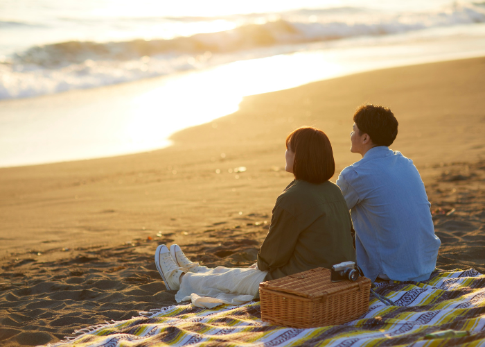 A couple sitting together and talking, symbolizing travel moments, love, and unforgettable experiences.
