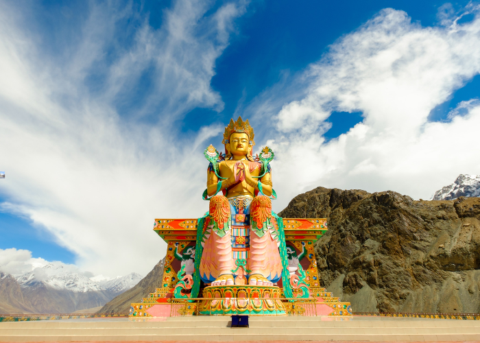 Diskit Monastery with giant Buddha statue overlooking Nubra Valley mountains