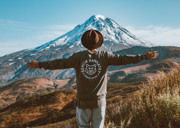 a boy standing alone in front of a mountain, symbolizing peace, solitude, and the real meaning of travel.