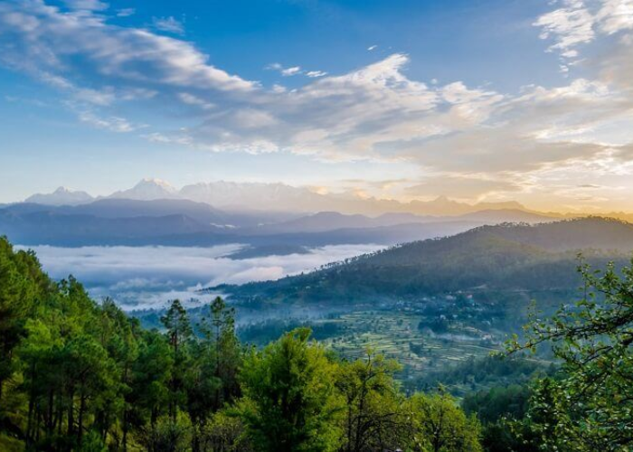 Panoramic sunrise view of snow-covered Nanda Devi peaks from Kausani in early winter
