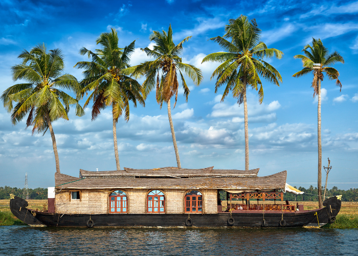 “Houseboat floating on serene backwaters of Alleppey, Kerala – best state to visit in India in April”